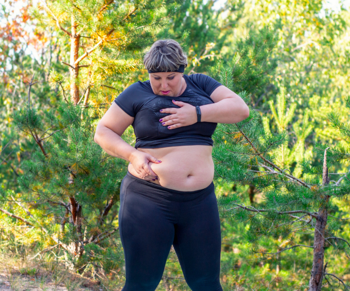 Foto de mulher fazendo exerc&iacute;cio e segurando sua barriga